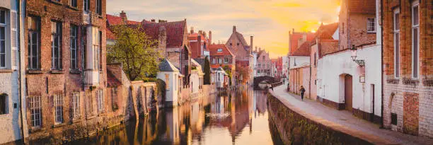 Panoramic view of the historic city center of Brugge in beautiful golden morning light at sunrise, province of West Flanders, Belgium