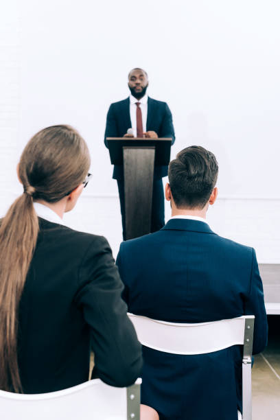istock handsome african american speaker talking during seminar in conference hall 1057330048