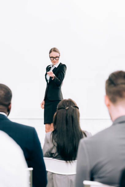 istock attractive lecturer pointing on multicultural audience during seminar in conference hall 1057330140