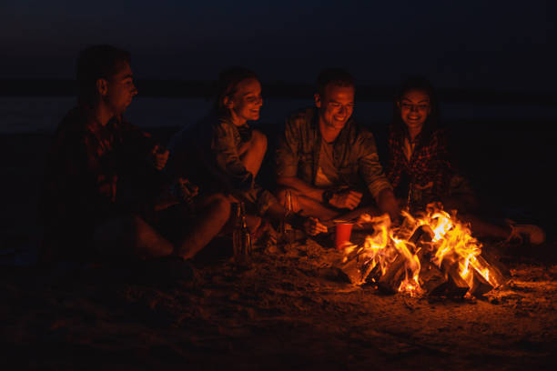 istock young friends have picnic with bonfire on the beach 1057333018