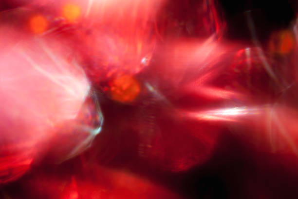 Smooth red specks of bright light shining on black background