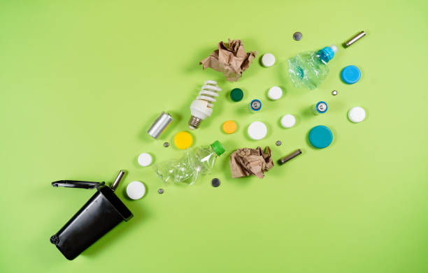istock Trash bins and assorted garbage isolated on green, recycle concept 1057338250