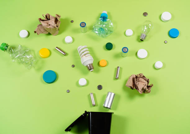 istock Trash bins and assorted garbage isolated on green, recycle concept 1057338252