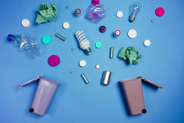 istock Trash bins and assorted garbage isolated on green, recycle concept 1057338326