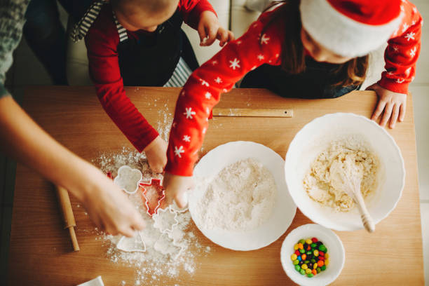 istock Children with parent making cookies 1057338344