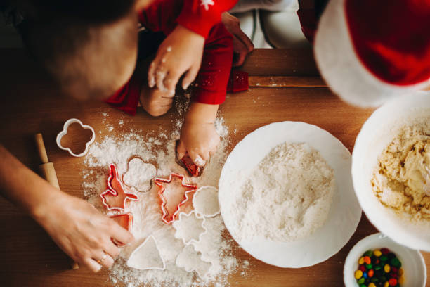istock Crop kids with mother playing with cookie cutters 1057338358