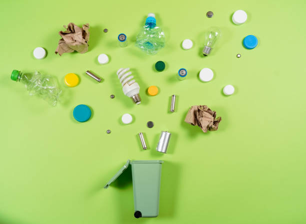 istock Trash bins and assorted garbage isolated on green, recycle concept 1057338360