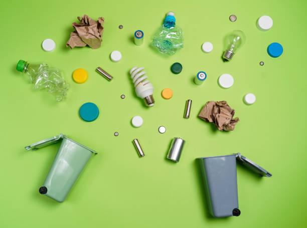 istock Trash bins and assorted garbage isolated on green, recycle concept 1057338364
