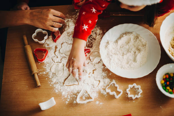 istock Crop kid with mother making cookies 1057338368