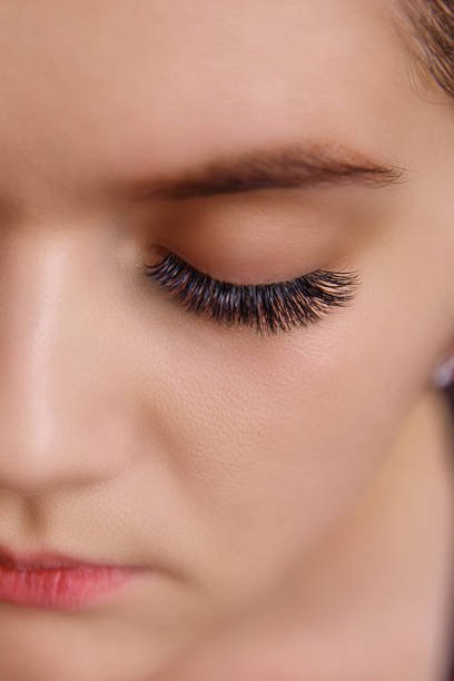 istock Eyelash Extension Procedure. Woman Eye with Long Eyelashes. Close up, selective focus. 1057340188