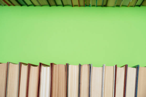istock Many Books Piles. Hardback books on wooden table. 1057342532