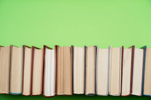 istock Many Books Piles. Hardback books on wooden table. 1057342536