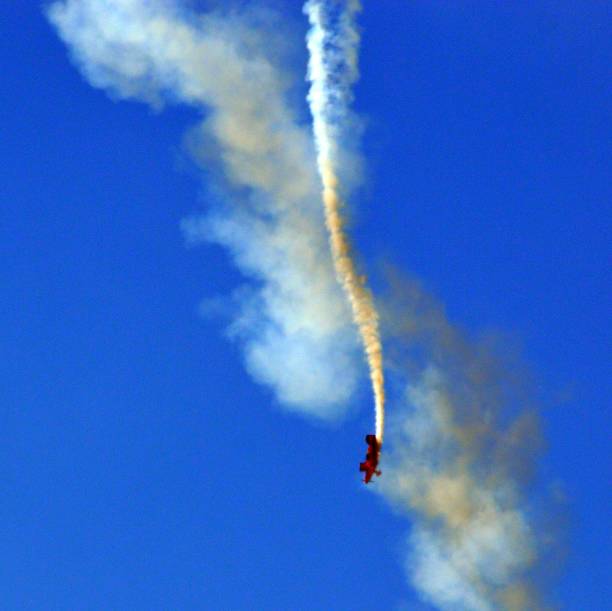 Small red airplane flying in a loop