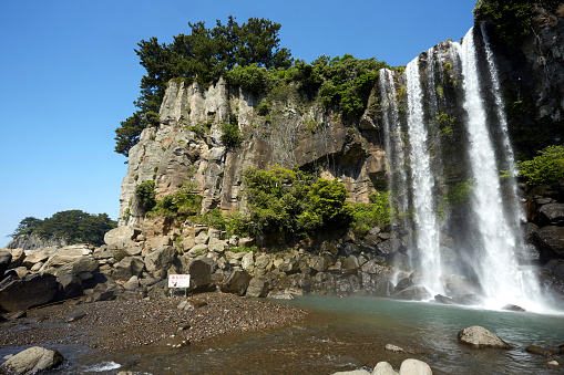 Jeongbang Falls is a popular tourist site on Jeju Island, South Korea.