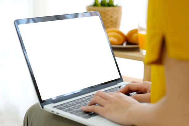 istock Woman hands using laptop computer with blank screen for mock up template background, business technology and lifestyle background concept 1057355980