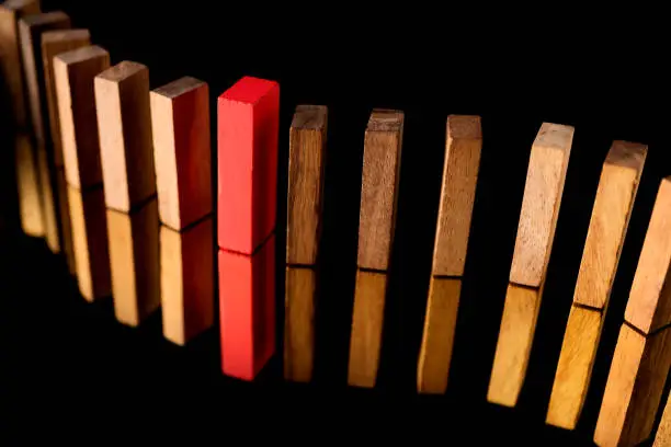 red wooden block with others wooden block in a row leadership ideas concept