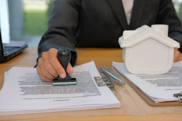 istock real estate agent stamping approved on mortgage loan contract agreement document 1057359204
