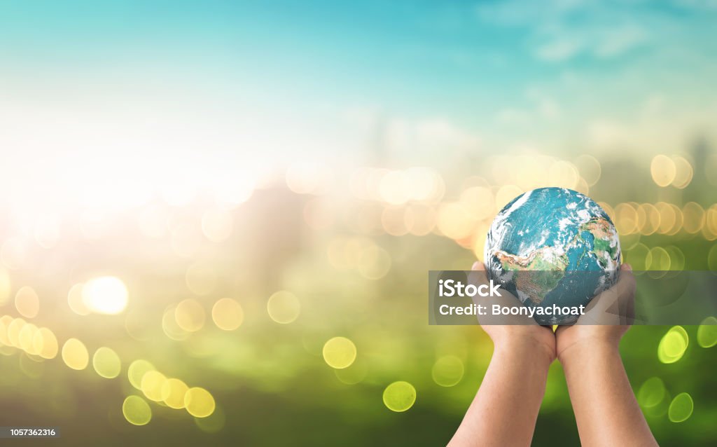 Sustainable community concept Human hands holding earth global over blurred green nature background. Elements of this image furnished by NASA Sustainable Lifestyle Stock Photo