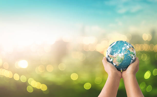 Sustainable community concept Human hands holding earth global over blurred green nature background. Elements of this image furnished by NASA world environment day stock pictures, royalty-free photos & images