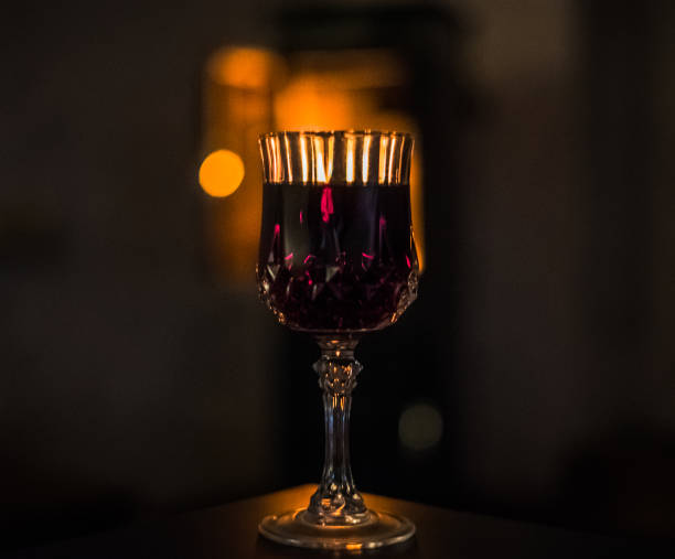 Glass of wine in front of a fireplace at home