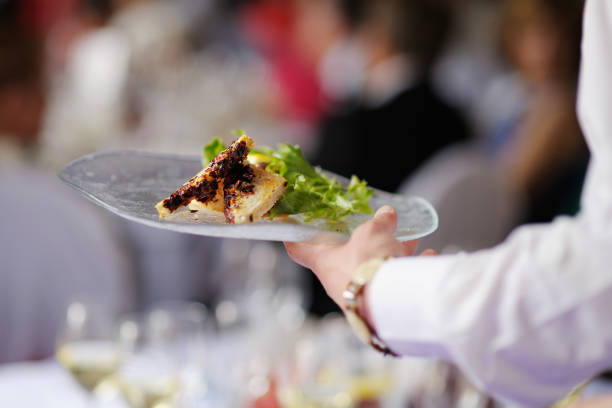 istock Waitress carrying a plate with meat dish 1057369616