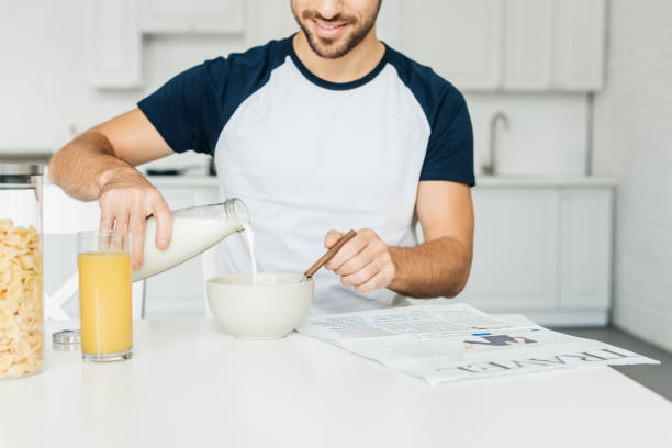 istock partial view of man having breakfast in kitchen at home 1057370674