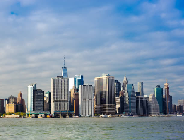 istock New York, NY: Sunlit Wall Street Cityscape From East River 1057373252