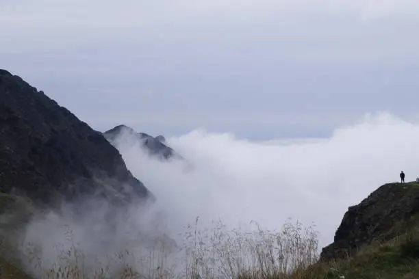 Mist over Balea Valley, morning thoughts, man overseeing fog.