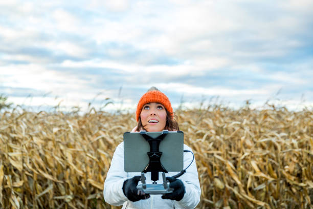 woman pilot using drone remote controller with a tablet mount - filming point of view fotos imagens e fotografias de stock