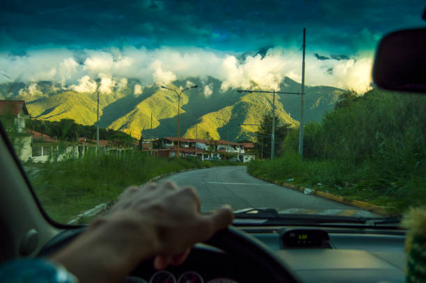 driving at the sunset,View from the driver angle car,to the green cloudy mountains Driving merida venezuela stock pictures, royalty-free photos & images