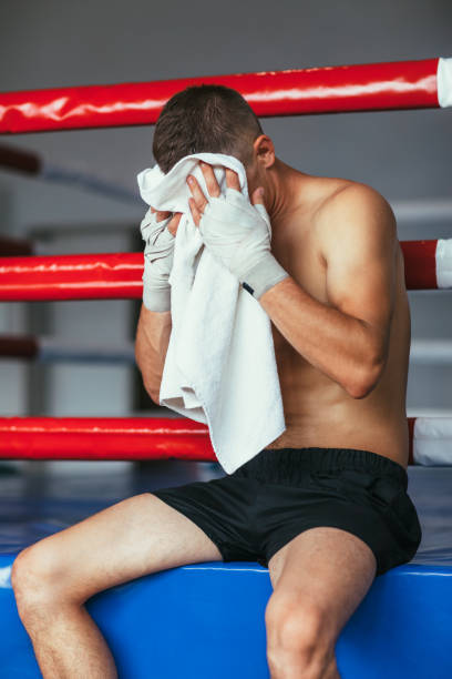 istock Boxer wiping the sweat after hard fight 1057383074