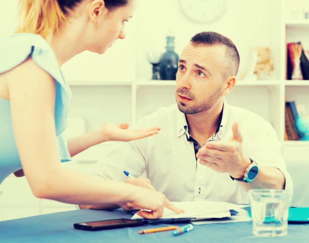 istock Man is reading a marriage contract at the table 1057389642