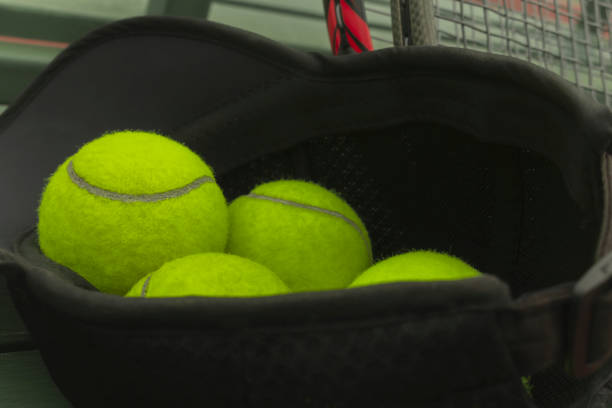 istock tennis ball on black sport hat 1057393162