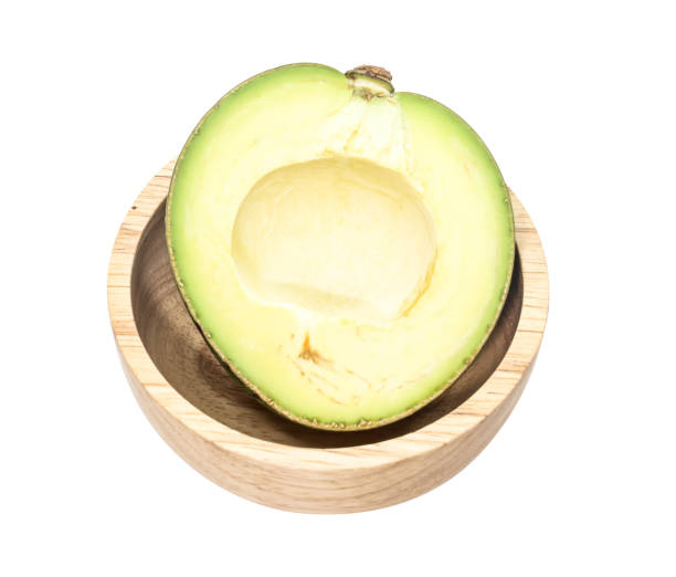Closeup Half of green thai avocado on wooden ,white background