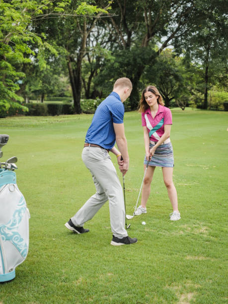 istock Golfer teaching his girlfriend how to play golf, lifestyle concept. 1057400604