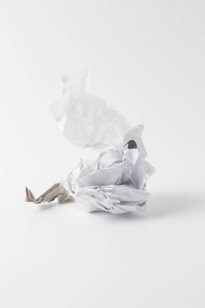 istock Crumpled paper ball isolated on White 1057403412