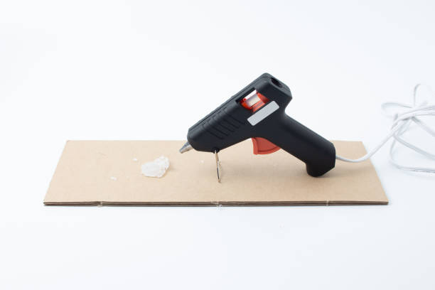 istock Electric hot glue gun isolated on white background 1057403522