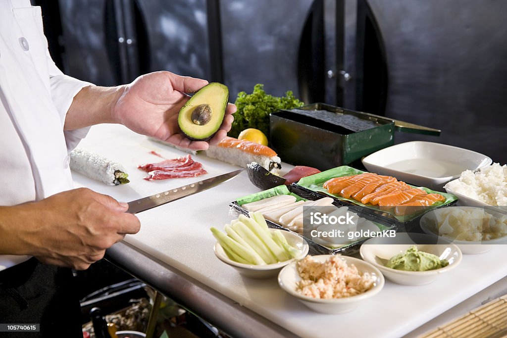 Japanese chef in restaurant with sushi ingredients Japanese chef in restaurant with fresh ingredients for making sushi rolls 40-49 Years Stock Photo