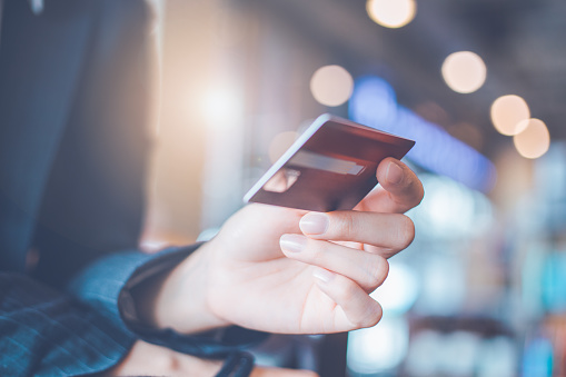 Business woman hand holding a credit card.