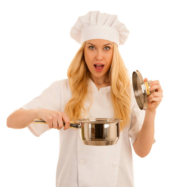 istock young blonde chef woamn holds kitchenware as she prepares to cook a meal isolated over white background 1057424042