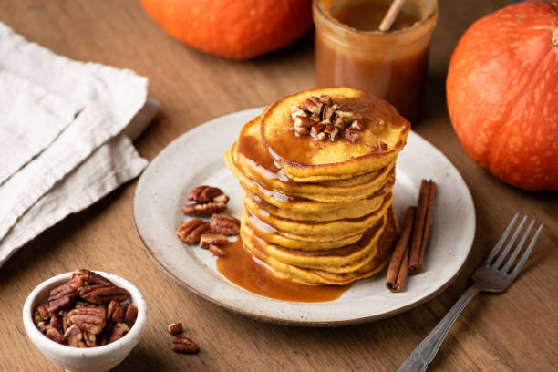 istock Homemade pumpkin pancakes with caramel and nuts 1057424200