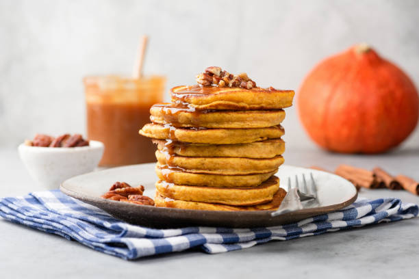 istock Stack of pumpkin pancakes with caramel sauce and pecan nuts 1057424202