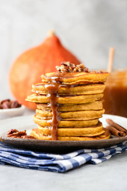 istock Pumpkin pancakes with caramel sauce and nuts on plate 1057424204