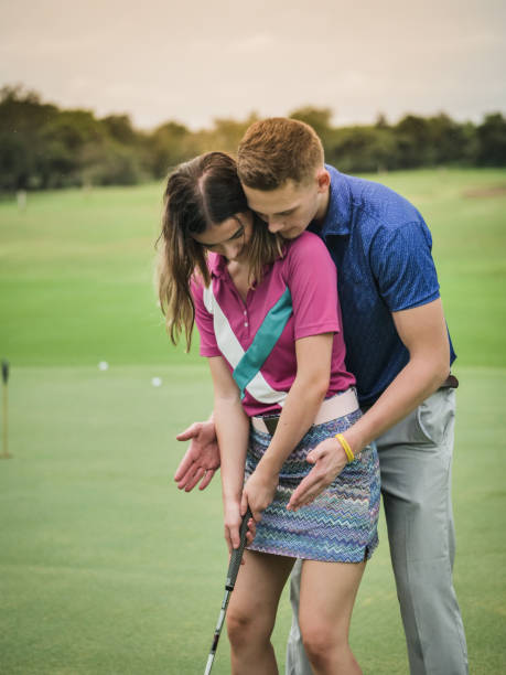 istock Golfer teaching his girlfriend how to play golf, lifestyle concept. 1057424258