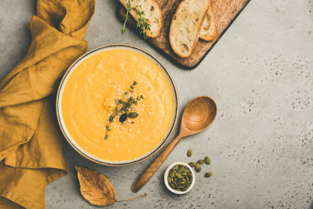 istock Pumpkin cream soup on concrete background 1057424372