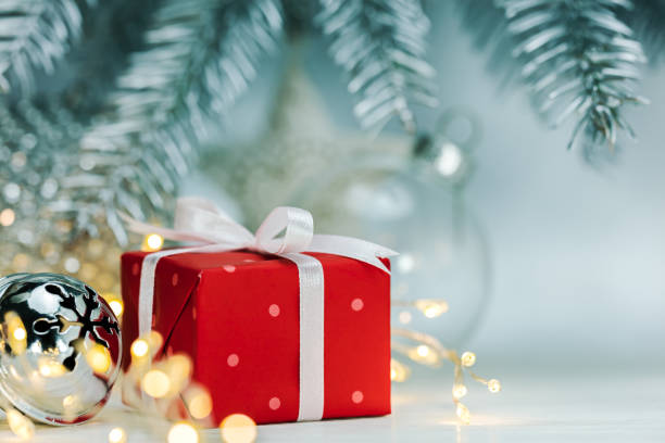 istock red christmas gift box on blurred silver background 1057437172
