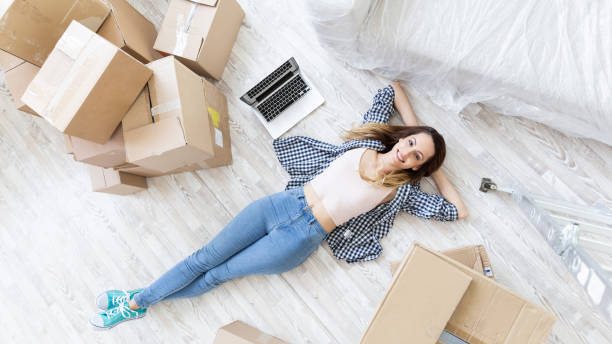 istock Young woman resting on floor in new home 1057439778