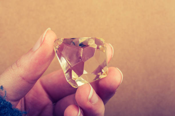 istock Fake diamond stone in hand 1057440138
