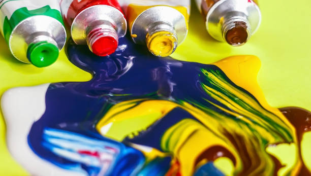 istock acrylic paint and artistic brush squeezed out against a yellow background, close-up, selective focus 1057449088