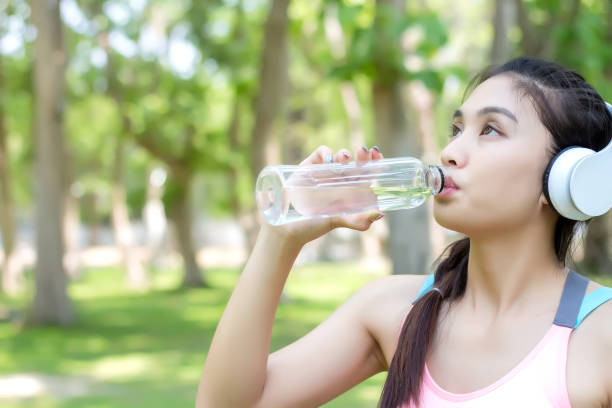 istock Asian young woman drinking water after workout exercising. 1057449206